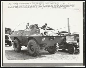 At least 500 military police and the Army's new V100 riot control vehicle (left) were camped at the city limits 5/1 for possible use 5/3 when antiwar demonstrators try to disrupt the government. The V100 is a huge armored vehicle with a turret and rubber tires which the Army has described as capable of running over a car.
