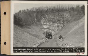 Contract No. 30, Stream Control Works at Main Dam, Swift River Reservoir, Belchertown, Enfield, Ware, downstream portal with drill carriages in place for drilling bench, diversion tunnel of stream control works, Belchertown, Mass., May 2, 1932