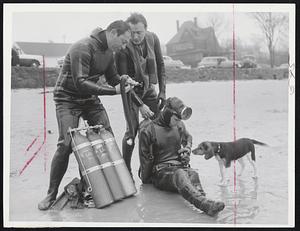 Equipment Check is made by, from left, Leo Spielberg of Lynn, Irving Lande of Newtonville and Frank Sanger, president of the New England Divers.