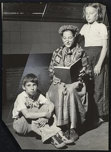 Top right, "Grandma" Josephine Pandolfo, aged 12, reads a story to her brother Nicholas, 10, and Catherine Tasha, 10, during a lull in club activities at the East Boston branch.