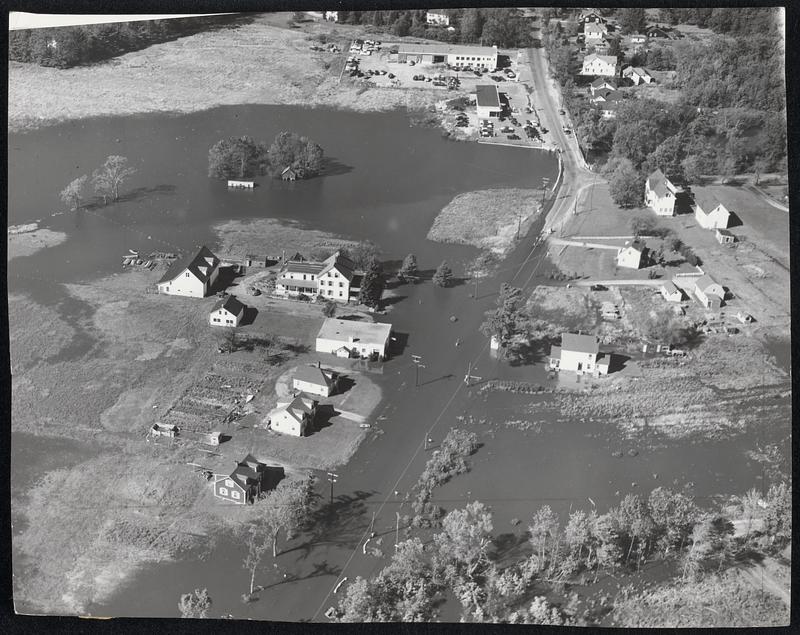 Over the Banks - Flood waters in the Exeter River overflow the banks and inundate the outskirts of Exeter blocking traffic. More than 150 persons in the town were forced to flee their homes.