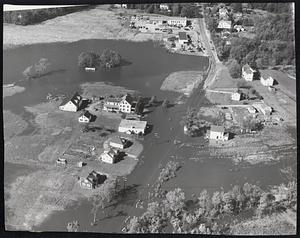 Over the Banks - Flood waters in the Exeter River overflow the banks and inundate the outskirts of Exeter blocking traffic. More than 150 persons in the town were forced to flee their homes.