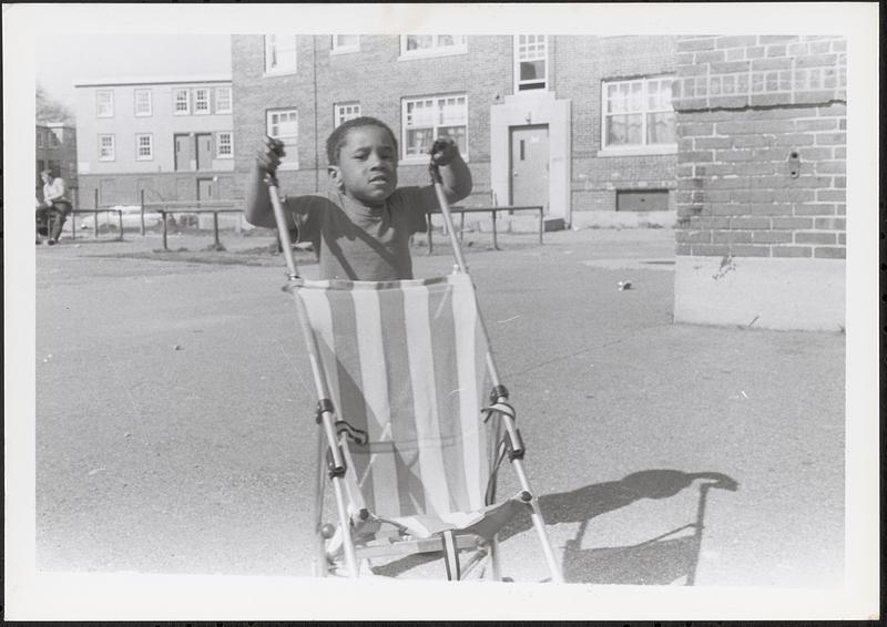 Jared pushing a stroller in Newtowne Court