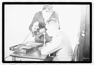 A man being shown images through an optical device