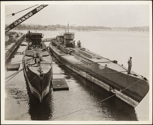 Two of the German U Boats are shown being unloaded