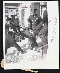 The Old Heave Ho--Three Metropolitan police officers bodily eject a student from the Iranian Embassy in Washington today as they bring an end to a sit-in demonstration being staged to protest the nationwide referendum Jan. 26 in Iran. The students had spent the night in the embassy lobby, refusing to leave the premises unless their protest was submitted to the government in Teheran.