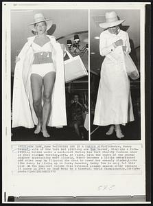 New York -- Turning Shy In A Candid Situation -- Mrs. Nancy Seaver, wife of New York Met pitching ace Tom Seaver, displays a form fitting bikini under a maxi-coat during New York charity fashion show at Shea Stadium Tuesday, left. At right, with the sight of the photographer approaching more closely, Nancy becomes a little embarrassed and shies away by flipping the coat to cover her womanly charms. Looks like Nancy is living up to form. However, hubby Tom is only 7-5 this year in the win-lost column this National League season after winning 25 games in 1969 to lead Mets to a baseball World Championship.