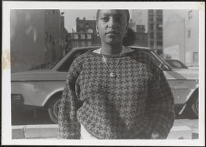 A woman standing near a car