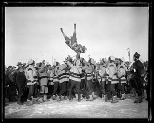 A person being thrown up in the air by a crowd