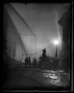 Firefighters using water hoses