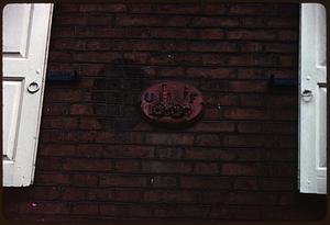 "UF" fire insurance mark on brick wall
