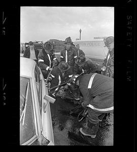 Firemen pry open door of car after accident, Jamaicaway