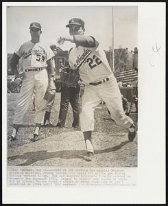 Johnny on the Spot--A Los Angeles Dodgers pitching mainstay, Johnny Podres (22) tests his ailing arm during Chicago workout today. The Los Angeles veteran’s form is watched by teammate Don Drysdale (53). Injury to Podres’ arm traces to being hit by pitcher Warren Spahn a couple of weeks back--and he isn’t scheduled to pitch until this weekend.