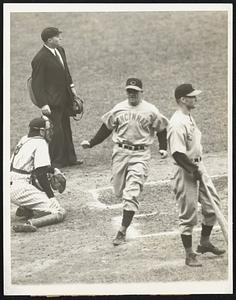 First run of series -- honors for the first run of the World Series opener between Yanks and Reds in New York Oct. 4 went to Ival Goodman of the Reds, seen scoring, above, on Frank McCormick's single, in the fourth inning. Yanks won the opener, 2-1