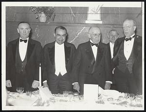 Among the principals at last night's testimonial dinner to George W. Mitton, chairman of the board of the Jordan, Marsh Company were, left to right, John V. Mahoney, representing Governor Hurley; Edward R. Mitton, president of the Jordan, Marsh Company; the guest of honor; and Mayor Mansfield.