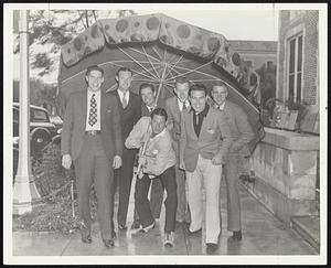 Al Schacht of the Red Sox, who whistles, does right by hurlers and reads poetry, remembers the line that goes, "In all climes we pitch our tents, cronies of the elements," and since the Red Sox are starting their pennant clime (cut it out, Al) and because the elements were unfavorable at Sarasota, he thought it might be appropriate to herd together these Sox pitching cronies and go out somewhere to pitch a tent, a good big tent, because the boys have to develop their arms. All these twirlers are rookies, but Al says they don't expect to "fold their tents like the Arabs and as silently steal away." Left to right-Bud Buetter, Alex Mustaikis, Schacht, Lee Rogers (behind him), Walter Ripley, Trainer Roland Logan and Stew Bowers.