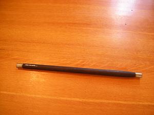 Flute of thin black cylindrical form with metal ends