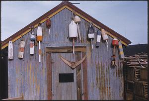 View of shack decorated with buoys