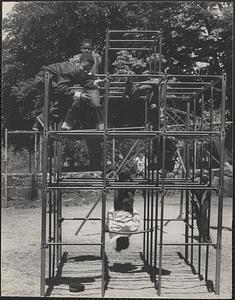 Boys playing on climbing frame, Boston