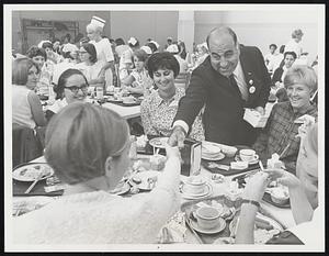 Hands Across the Table - Mayoral candidate and businessman Nicholas Abraham greets nurses and workers at Boston City Hospital cafeteria during luncheon period.