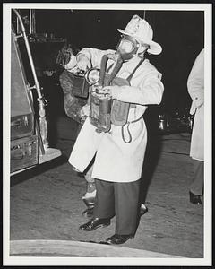 Louis Lebberattori - Engine 3 assists Deputy Chief John Howard in donning new Navy type gas mask before he entered the Federal Bldg