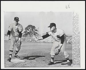 Fox and his New Keystone Partner-- Nellie Fox, Chicago White Sox second baseman, works around second base with the club's new shortstop, Ron Hansen (left) as the foul squad reported for spring training workouts in Sarasota today. Hansen is expected to fill the shoes of shortstop Louie Aparicio who was traded to the Baltimore Orioles.