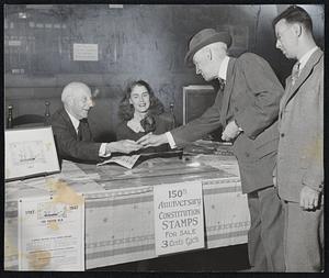 ‘Old Ironsides’ Stamps—In the historical shipping atmosphere of the main office of the State Street Trust Company, Charles Francis Adams, chairman of the board and former secretary of the Navy, launches the sale of the Constitution stamp. Allan Forbes, president of the company, is the first customer. Center is Dixie Arnold, who will sell the stamps, while (right) is Everett Cook, president of Bank Stamp Club.