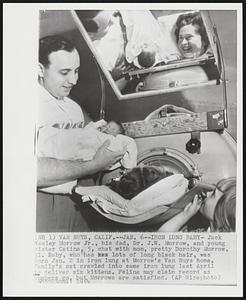 Iron Lung Baby-Jack Wesley Morrow Jr., his dad, Dr. J.W. Morrow, and young sister Catina, 5, chat with mom, pretty Dorothy Morrow, 31. baby, who has lots of long black hair, was born Jan. 2 in iron lung at Morrow's Van Nuys home. Family's cat crawld into same iron lung last April to deliver six kittens. Feline may claim record as numbers go, but Morrows are satisfied.