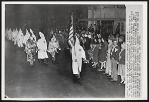 Grand Dragon Parades- Dr. Samuel Green (left,foreground,unmasked), Georgia Grand Dragon of the Ku Klux Klan,heads parade of nearly 300 klansmen through Wrightsville streets last night to courthouse lawn where a cross was burned. Green sharply criticized president Truman’s civil rights program. Wrightsville is the county seat of Johnson county where a democratic primary was held today to nominate new county officers.