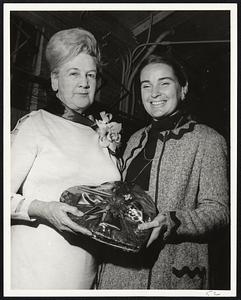 Receiving gifts from Mrs. Kevin H. White, right, after being crowned "senior citizen queen" at L Street Center, South Boston, is Mrs. Alice Kelley of South Boston. The fete was one of a series of Valentine parties hosted by Mayor White and the Boston Parks and Recreation Dept. yesterday.