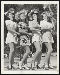 Bonnets of Blossoms-These colorful results were achieved by socialites taking part in a hat-making contest at Pasadena, Calif. Live blossoms were used to build the bonnets during an outdoor fete held at fashionable Huntington Gardens there.