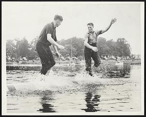 "King of The White Water" Retains Crown. Gladstone, Mich. -- A acne during the final battle for the title "King of The White Water'' at the National Log Rolling Tournament here on the fourth of July weekend, is Joe Connor (left) of Cloquet, Minn. and Jimmy Herron of Kelso, Wash., defending champion, fought it out on the smallest and fastest log that is used. Herron finally caught Connor off guard for a fraction of a second and used this pause to throw him off balance.