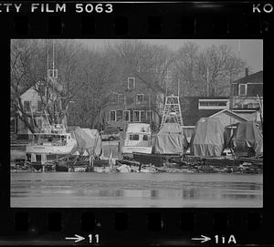 Boats on land along the water