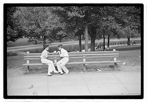 Two men sitting on a bench by Frog Pond, Boston Common