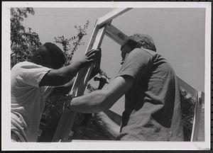 Young men building a structure