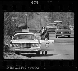 Waltham policeman uses cruiser radio, Waltham, MA