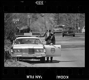 Waltham policeman uses cruiser radio, Waltham, MA