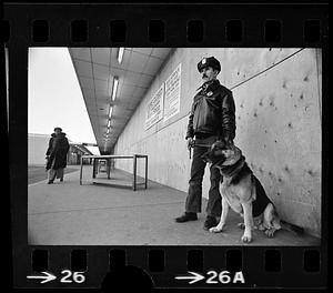 Security guard and dog at boarded-up Columbia Point stores, Dorchester