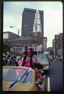 Female impersonator at gay pride parade, Tremont Street, note Park Street Church, Boston