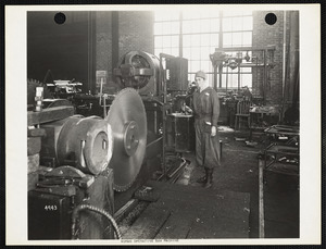 Woman operating saw machine