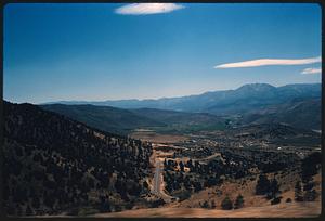 View from above of hillside road and valley, likely Nevada