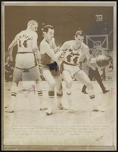 Darrall Imhoff plants himself securely and Hawk Richie Guerin finds it a tight squeeze as Jerry West drives close to Imhoff and goes on to score for the Lakers.