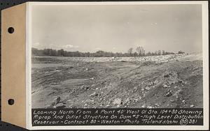 Contract No. 80, High Level Distribution Reservoir, Weston, looking north from a point 40 feet west of Sta. 104+80 showing riprap and outlet structure on dam 5, high level distribution reservoir, Weston, Mass., May 29, 1940