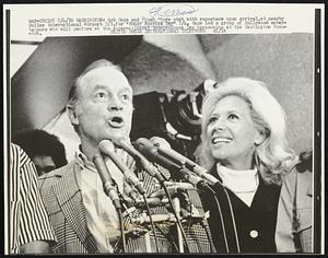 Washington: Bob Hope and Dinah Shore chat with reporters upon arrival, at nearby Dulles International Airport 7/3, for "Honor America Day" 7/4. Hope led a group of Hollywood entertainers who will perform at the super-colossal Independence Day ceremonies at the Washington Monument.