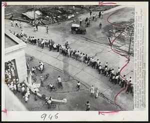 Fukui Residents Line up for Ration Tickets-- Residents of Fukui, Japan line up on Earthquake cracked street to wait for food ration tickets after the town was destroyed by a temblor and fire, June 28. Photo by Charles Gorry, associated Press Photographer.