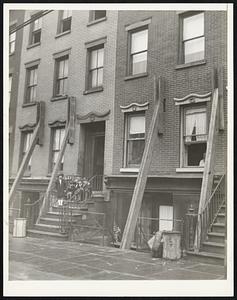 [illegible] were propped against this residence on Sackett street, N.Y., after Thursday night's earthquake, but the occupants were not forced to abandon it as in some cases there.