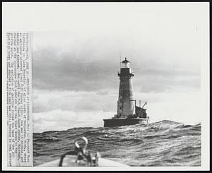 Explosion at Lighthouse--This is Stannard Rock lighthouse in Lake Superior, 45 miles north of Marquette, Mich., where an explosion occurred about 9:30 Sunday night. One man is missing, and another was injured. Not until the U.S. Coast Guard cutter, Woodrush, checked at the lighthouse last midnight was the blast known to the outside world. The explosion of gasoline gutted the base of the 102-foot high tower and started a fire that was still burning in coal storage