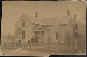 Colburn Family standing in front of their house
