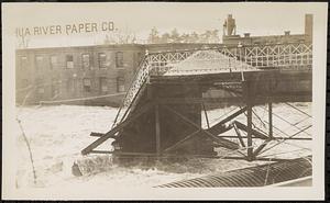 Main St. bridge being swept away by flood waters