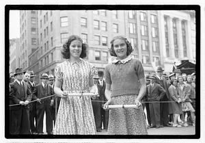 Two young women holding awards